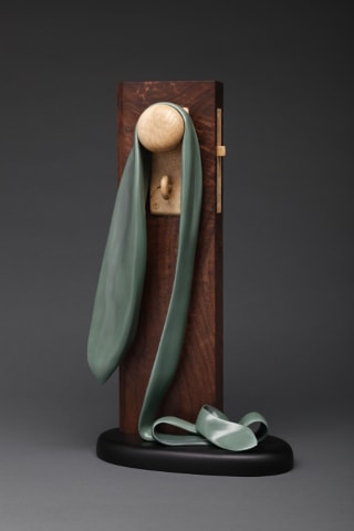 Green fabric sphere wooden stand sculpture