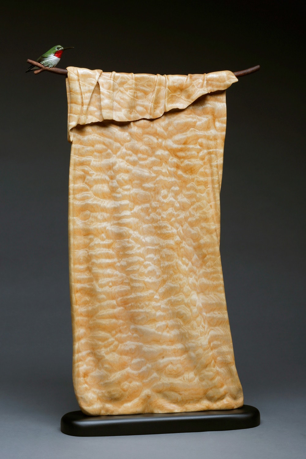 Hummingbird on cream fabric carved pattern branch sculpture